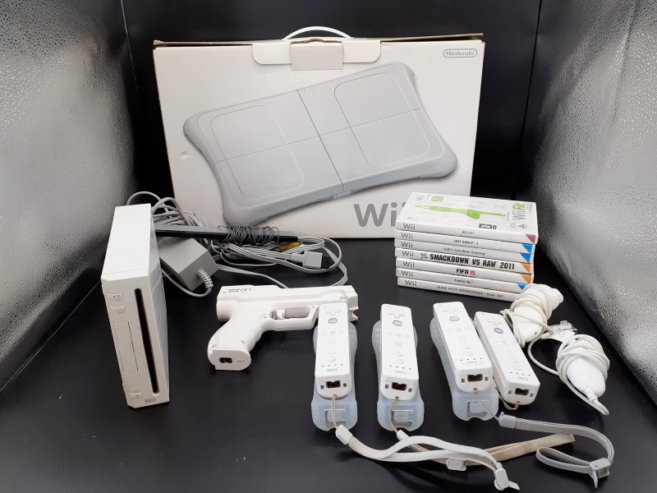 Nintendo Wii + 4 manettes + 2 nunchuks + 1 pistolet Wii + 7 jeux + Wii fit balance board