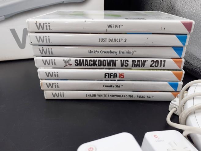 Nintendo Wii + 4 manettes + 2 nunchuks + 1 pistolet Wii + 7 jeux + Wii fit balance board